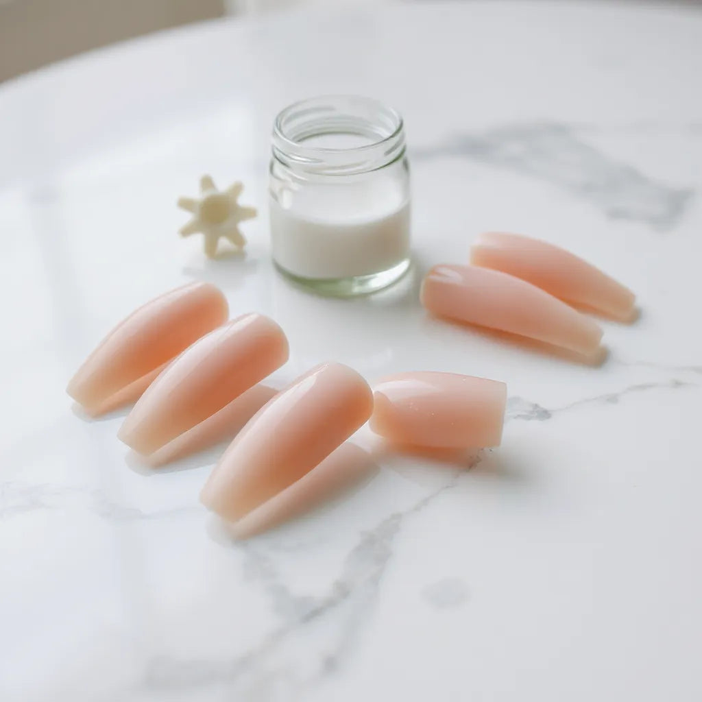 Glossy press-on nails arranged with a natural look on a clean manicure surface