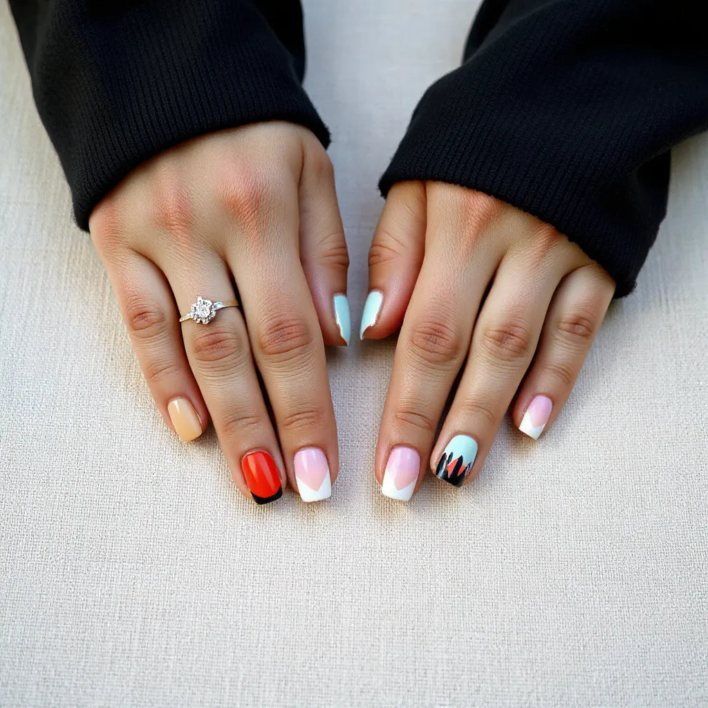 Hands with multicolor nails featuring gradient and geometric accents on a neutral background