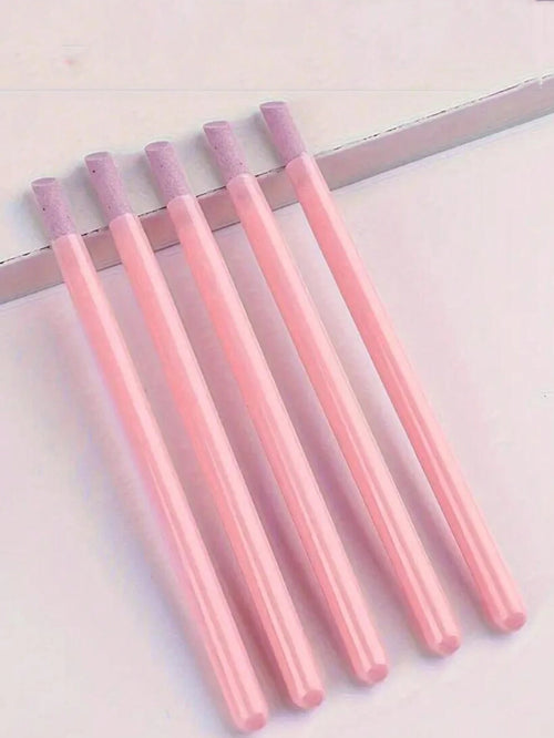 Set of pink markers with purple caps on a light background