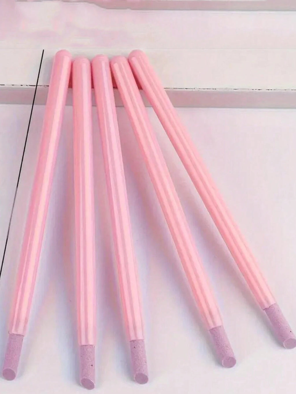 Set of pink markers with gradient tips on a white background