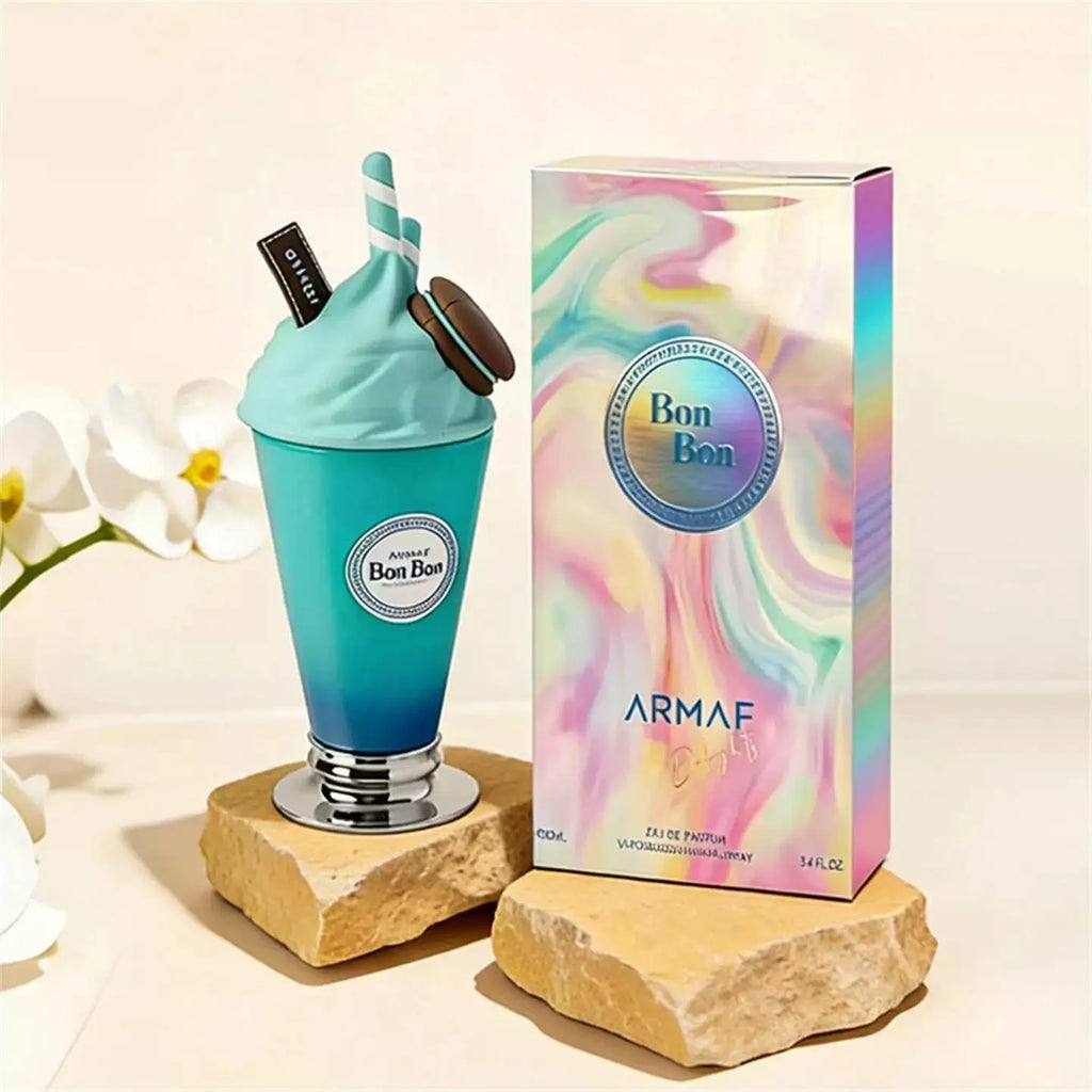 Blue perfume bottle and packaging with 'Bon Bon' branding on a light background