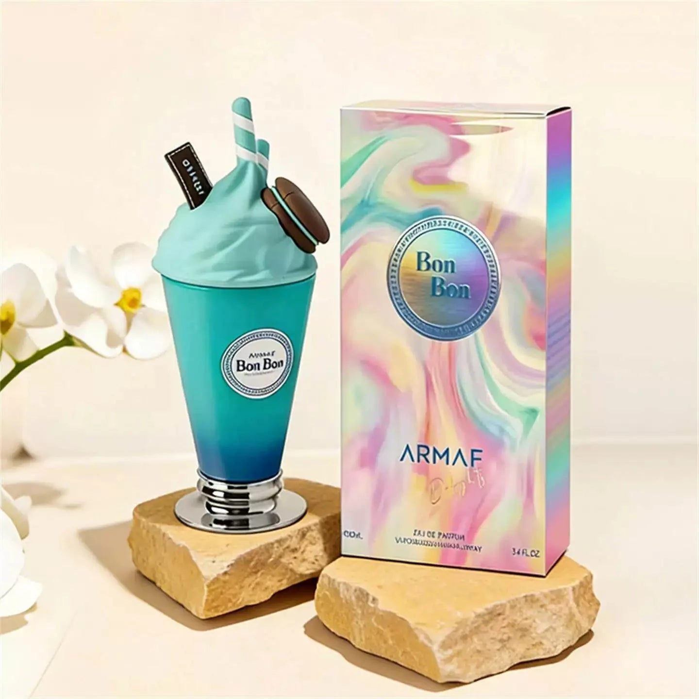 Blue perfume bottle and packaging with 'Bon Bon' branding on a light background