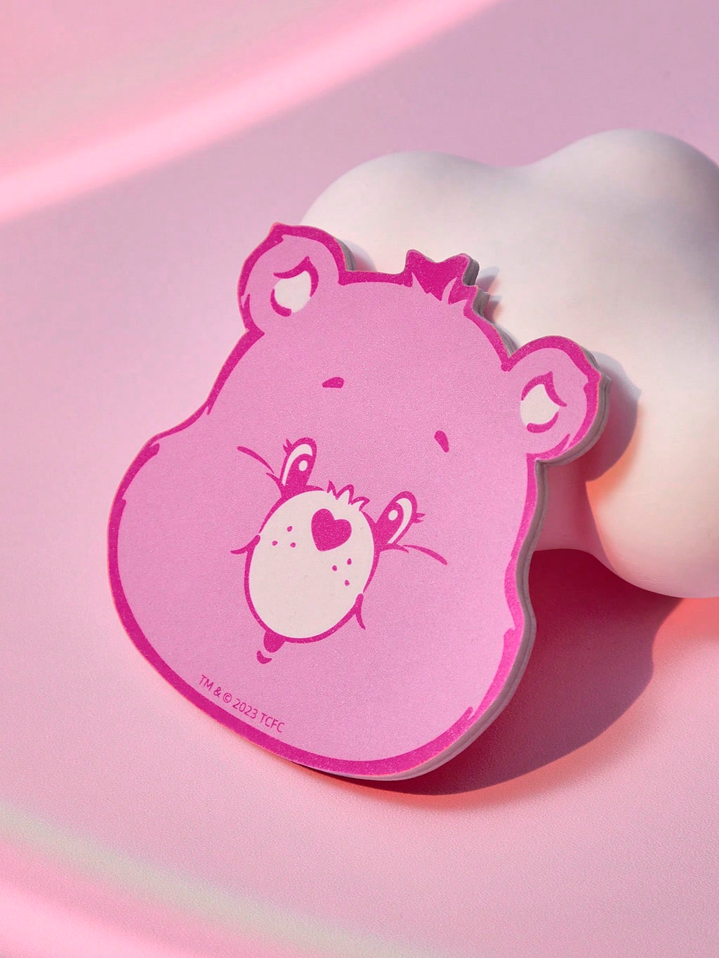 Pink cartoon character head on a pink background