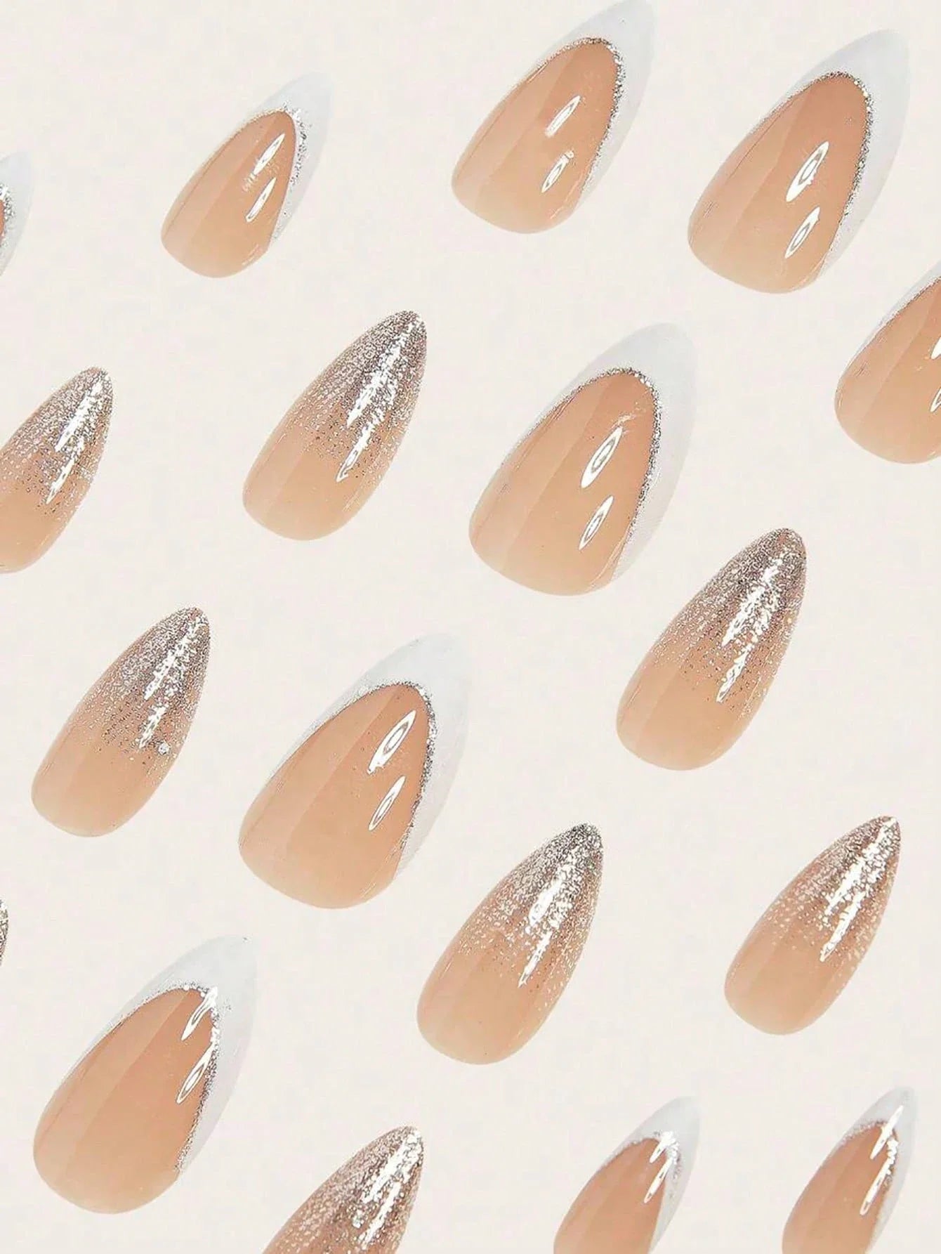 Nail art design with nude and silver gradient nails on a light background