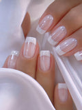 Close-up of a hand with French manicure nails on a white background