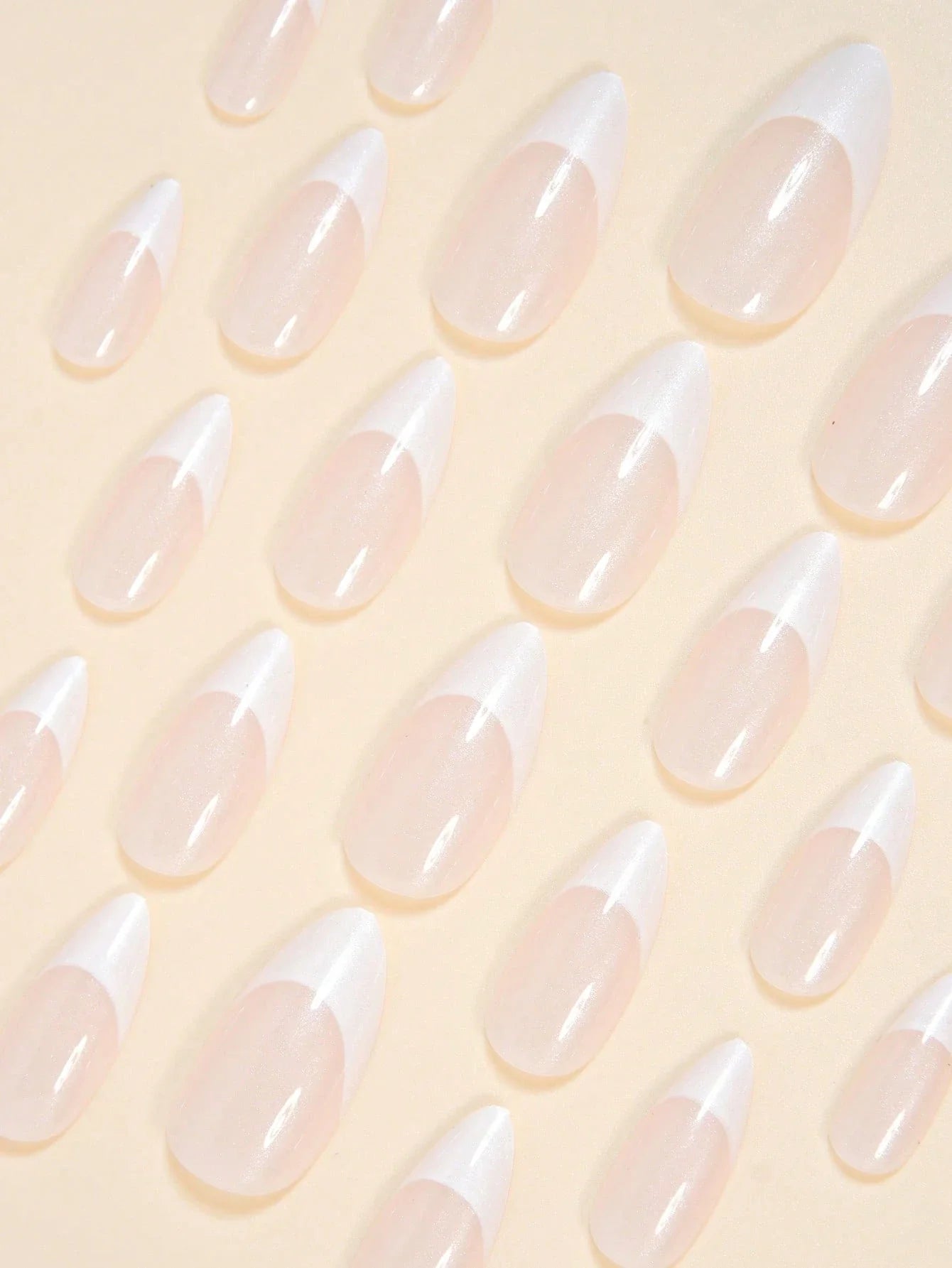 Translucent nail tips on a light yellow background