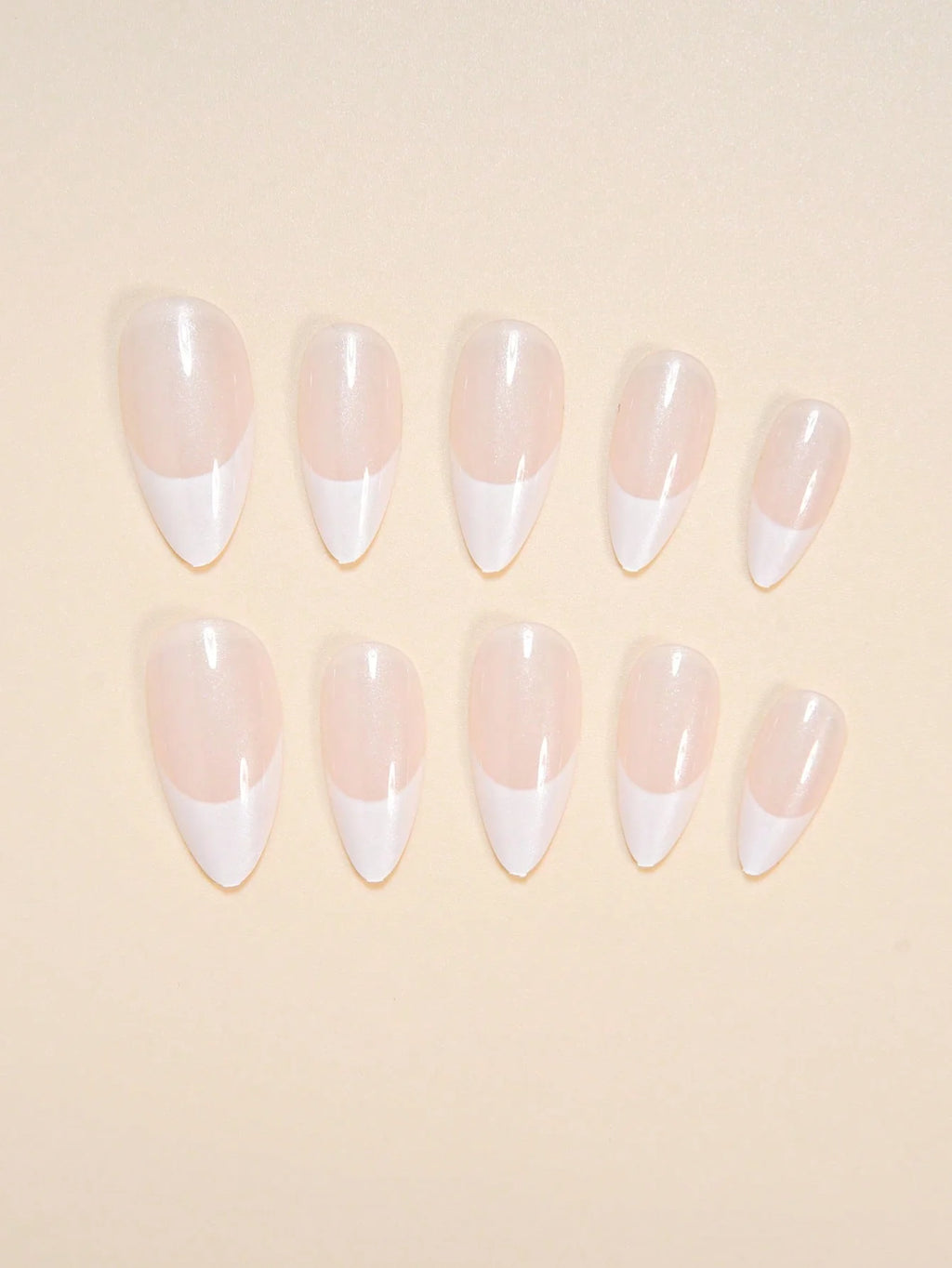 Set of press-on nails with a gradient design on a beige background