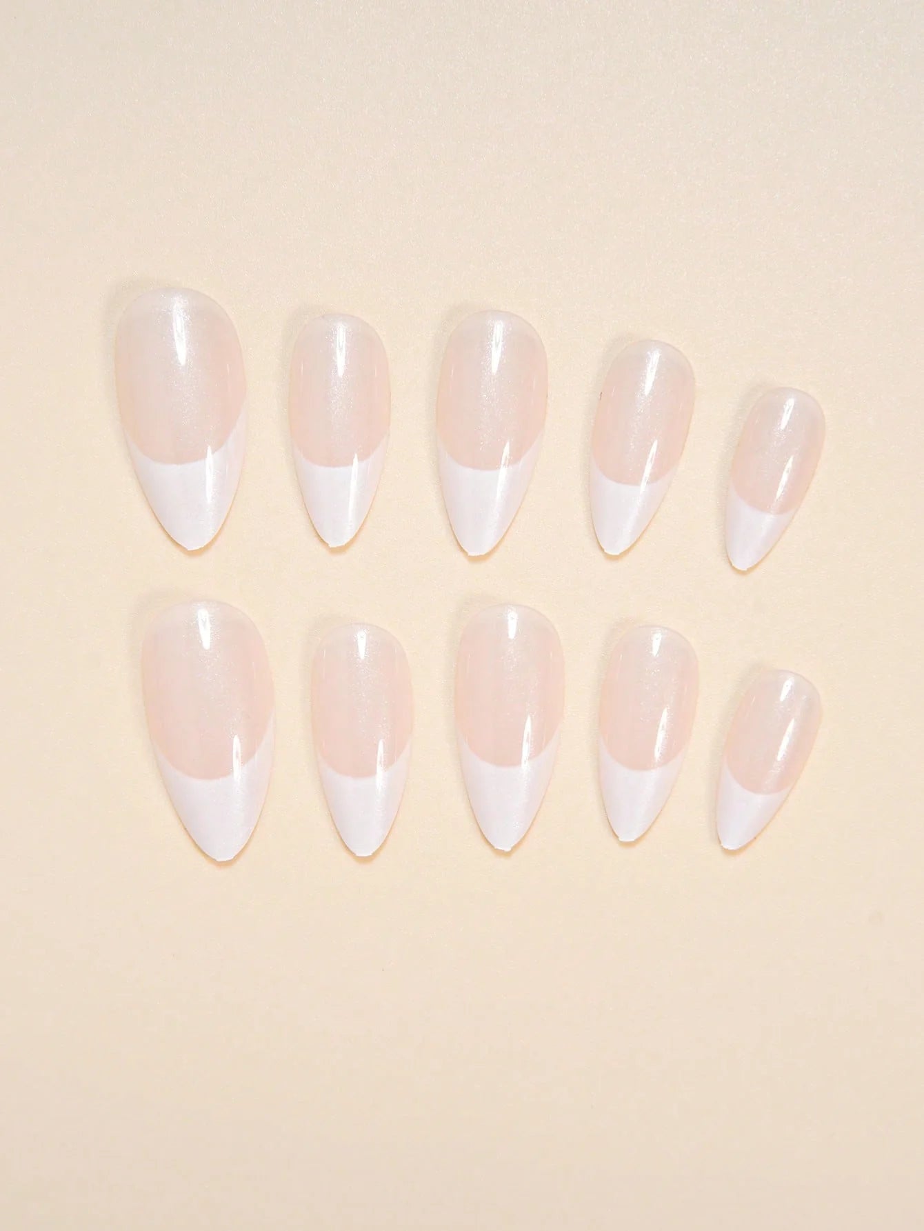 Set of press-on nails with a gradient design on a beige background