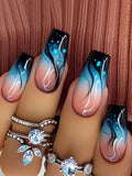 Nails with gradient design in black, blue, and pink on a wooden background