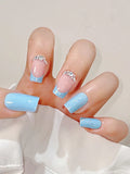Hand with light blue and pink nail polish featuring rhinestones on a white background