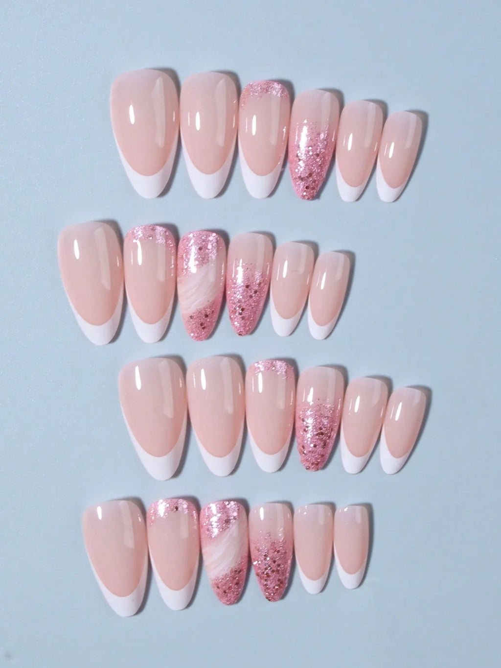 Set of pink and white gradient nail designs with glitter on a light blue background
