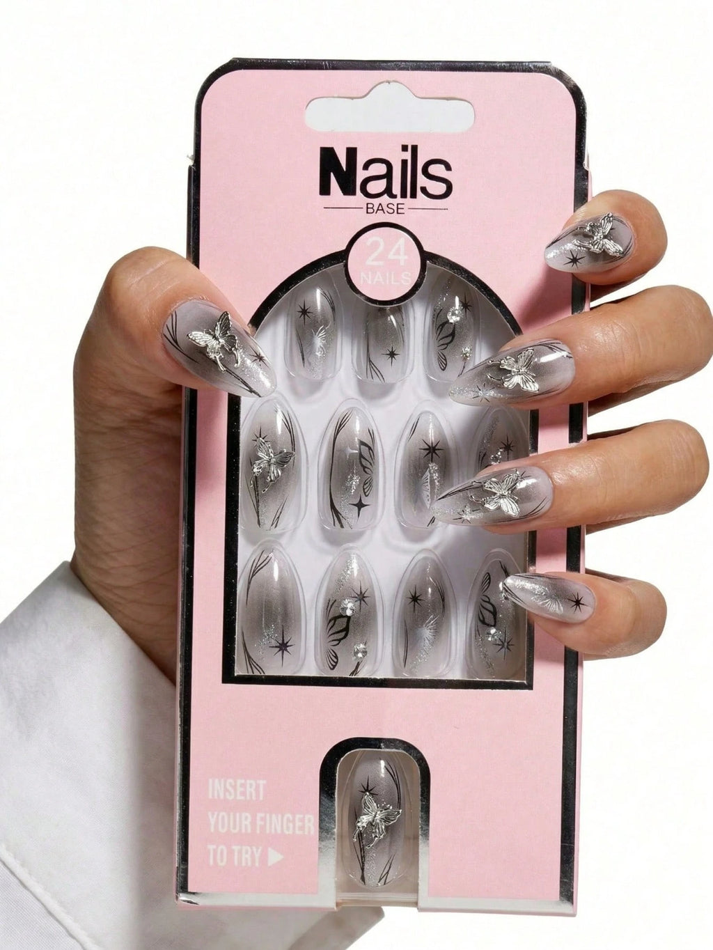 Packaged nail extensions with a hand displaying nails wearing similar extensions on a white background