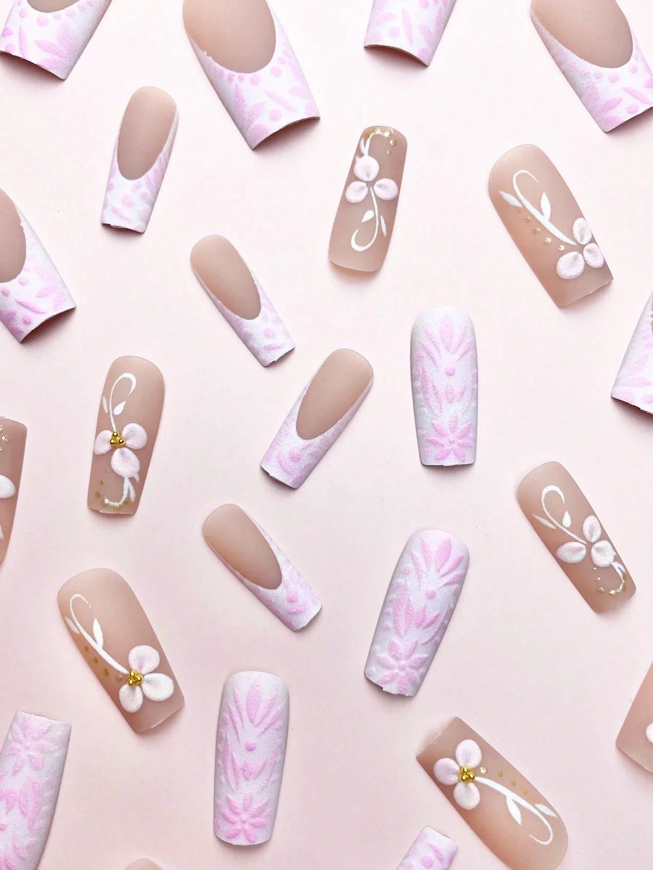Collection of nail art designs on a light pink background