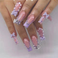 Nails with decorative bows and rhinestones on a white background