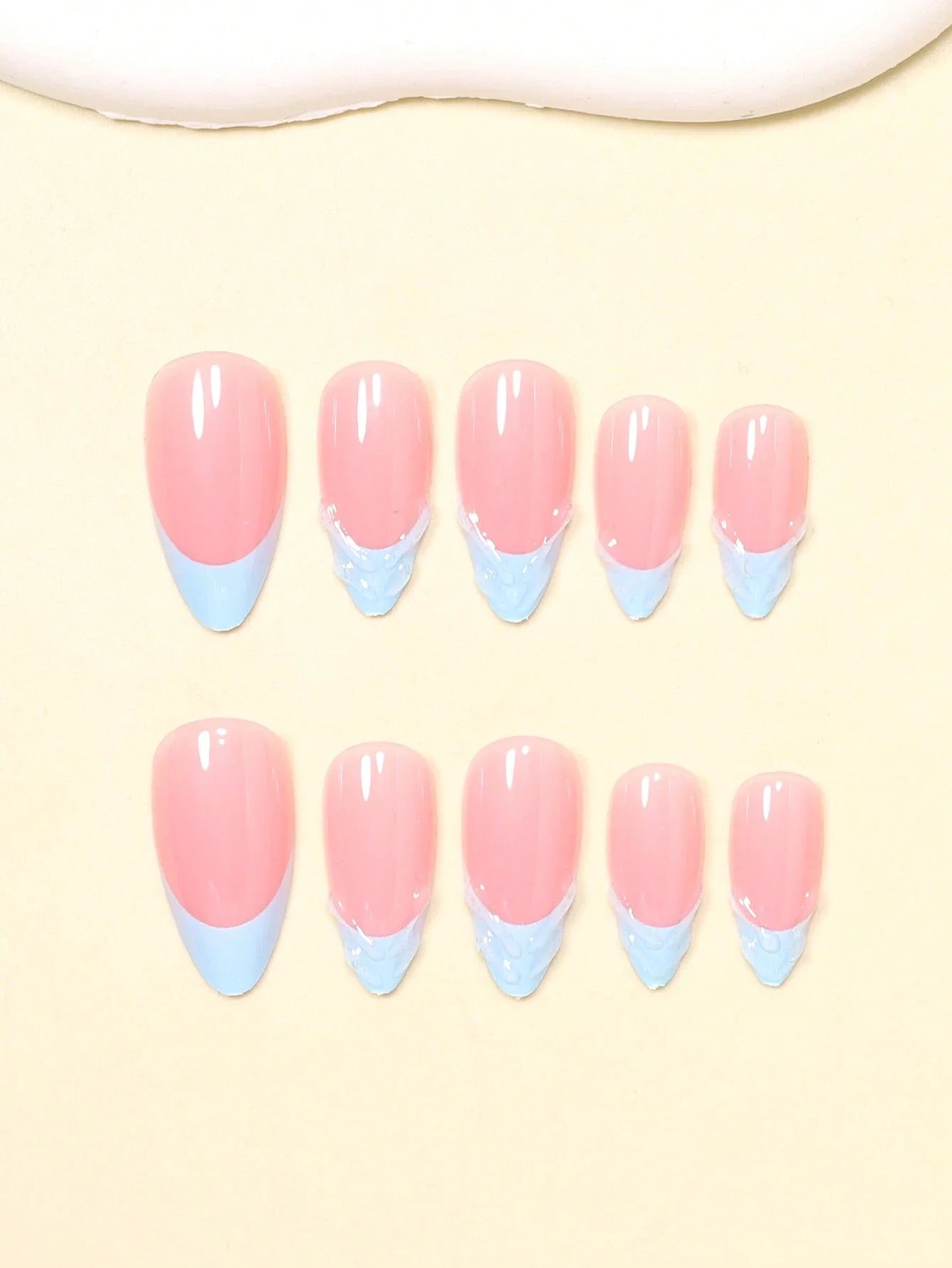 Set of pink and blue gradient nail art on a beige background