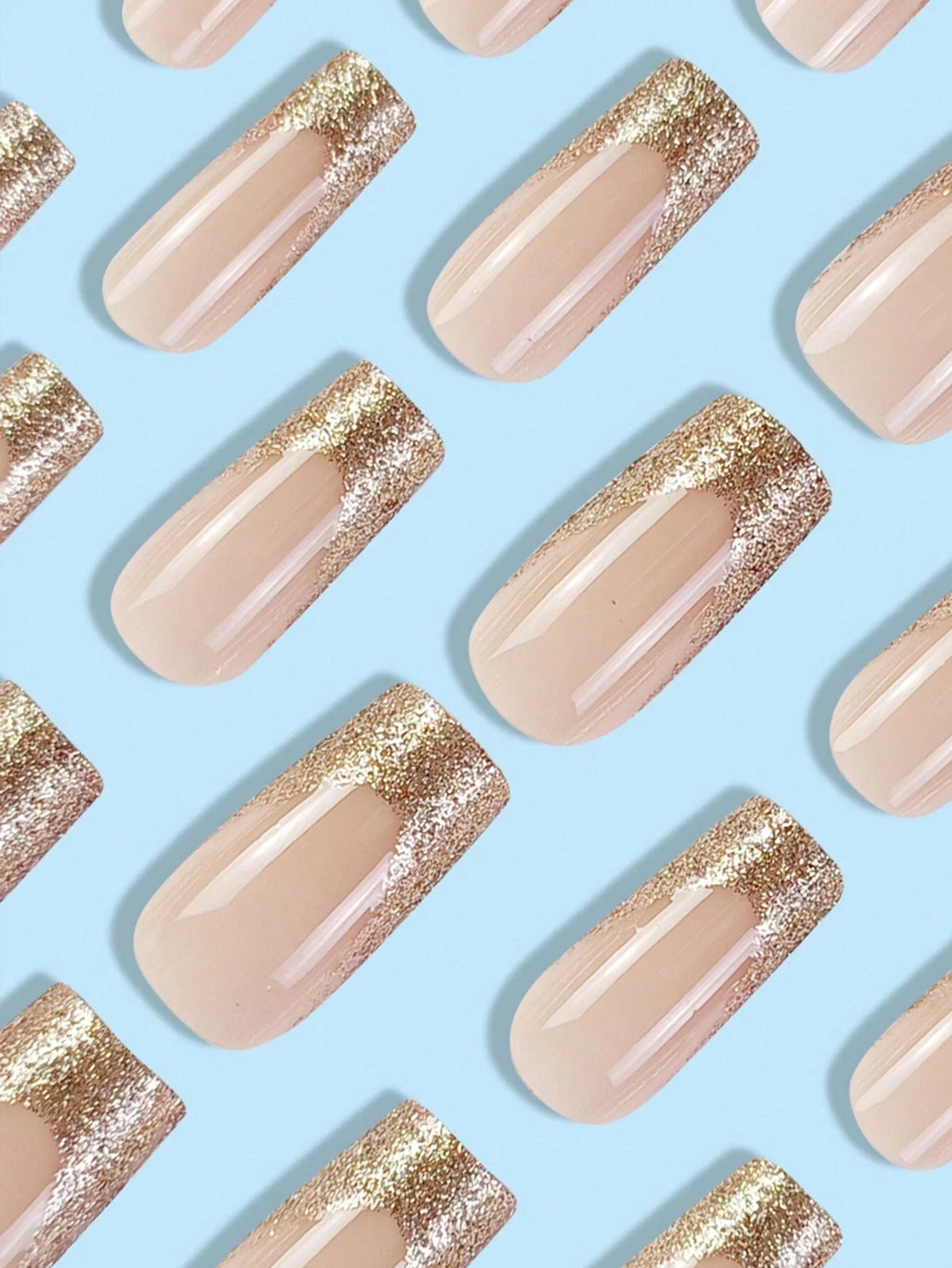 Pattern of beige nails with gold glitter on a light blue background