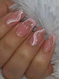 Pink nails with silver glitter design on a white background