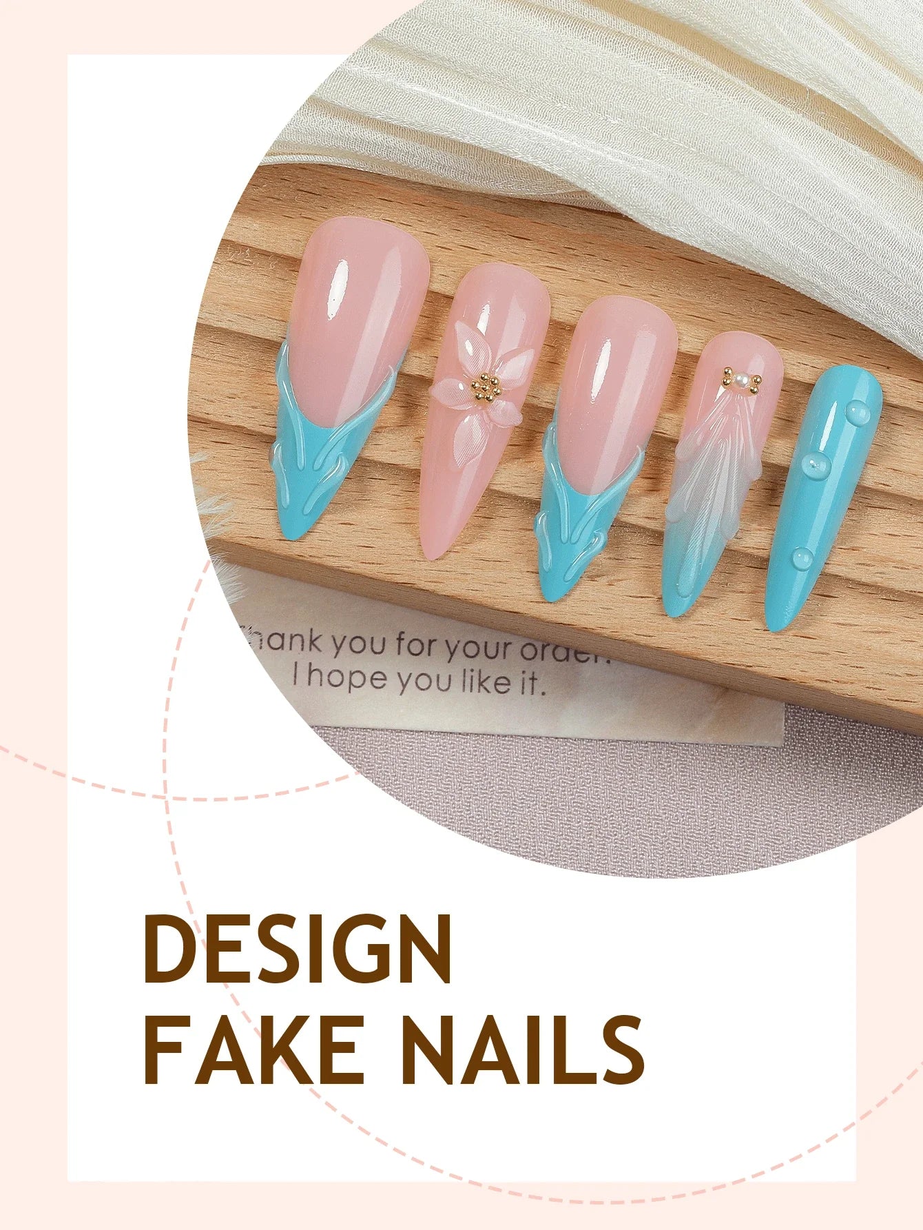 Design fake nails with pink and blue design on a wooden board.